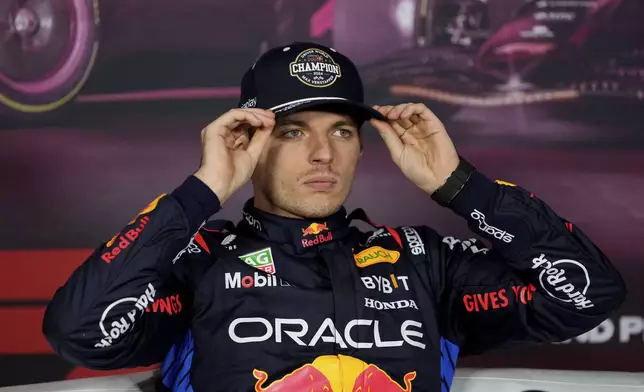 Red Bull driver Max Verstappen, of the Netherlands, adjusts his hat while conducting an interview after the F1 Las Vegas Grand Prix auto race, Sunday, Nov. 24, 2024, in Las Vegas. (AP Photo/Matt York)