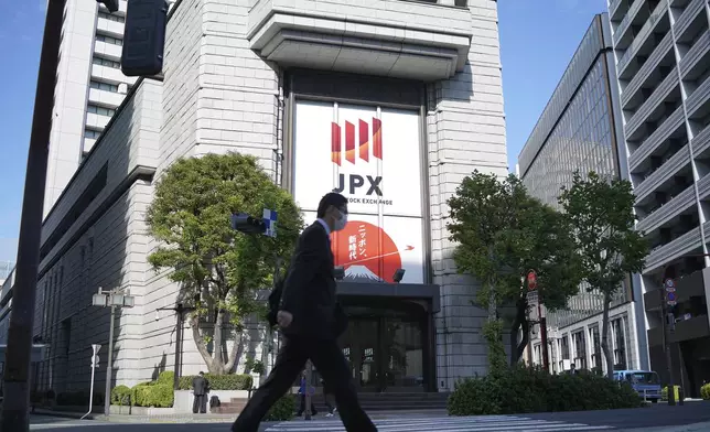 A person walks in front of the Tokyo Stock Exchange building at a securities firm Tuesday, Nov. 26, 2024, in Tokyo. (AP Photo/Eugene Hoshiko)