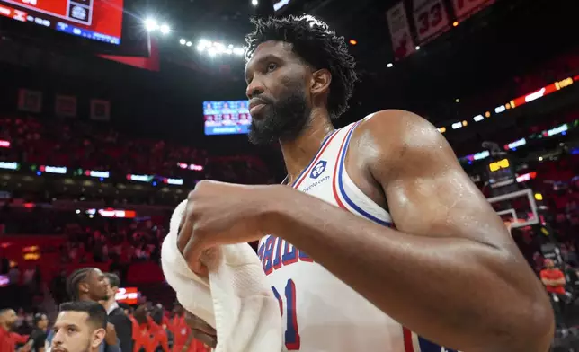 Philadelphia 76ers center Joel Embiid walks off the court after an NBA basketball game against the Miami Heat, Monday, Nov. 18, 2024, in Miami. (AP Photo/Lynne Sladky)