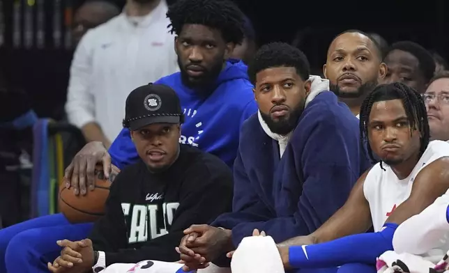 Philadelphia 76ers' Kyle Lowry, from left, Joel Embiid, Paul George, Eric Gordon and Ricky Council IV watch from the bench during the second half of an NBA basketball game, Sunday, Nov. 24, 2024, in Philadelphia. (AP Photo/Matt Slocum)