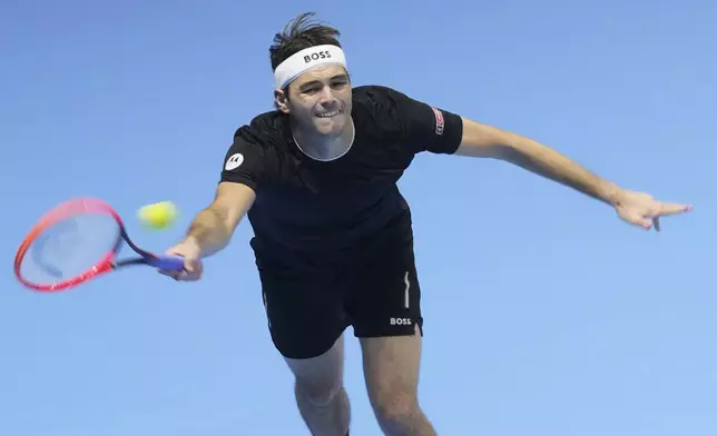 Taylor Fritz of the United States returns to Germany's Alexander Zverev during their semifinal tennis match of the ATP World Tour Finals at the Inalpi Arena in Turin, Italy, Saturday, Nov. 16, 2024. (AP Photo/Antonio Calanni)