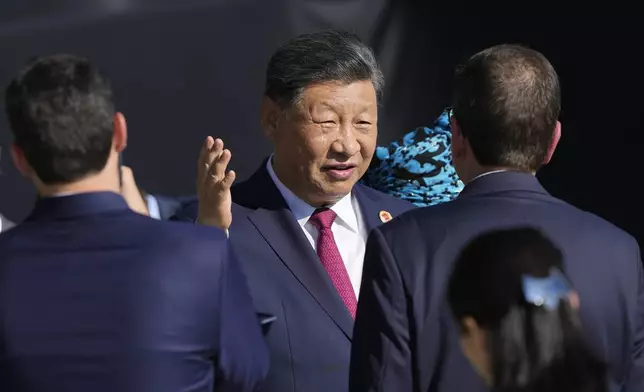 China's President Xi Jinping talks after joining a group photo during the G20 Summit in Rio de Janeiro, Monday, Nov. 18, 2024. (AP Photo/Eraldo Peres)