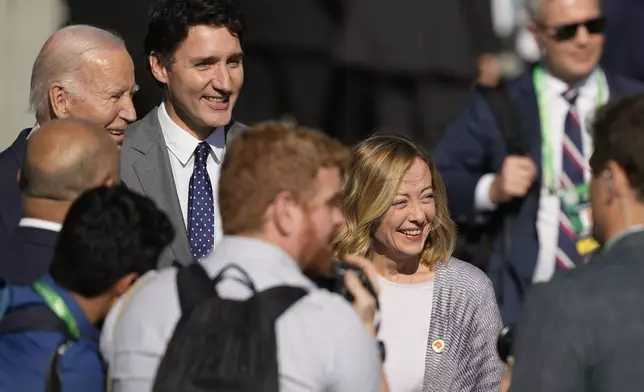 U.S. President Joe Biden, top left, Canada's Prime Minister Justin Trudeau, second from top left, and Italy's Prime Minister Giorgia Meloni arrive late for the group photo at the G20 Summit in Rio de Janeiro, Monday, Nov. 18, 2024. (AP Photo/Eraldo Peres)