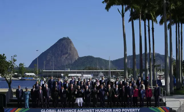 Backdropped by Sugar Loaf mountain, leaders attending the G20 Summit pose for a group photo in Rio de Janeiro, Monday, Nov. 18, 2024. (AP Photo/Eraldo Peres)