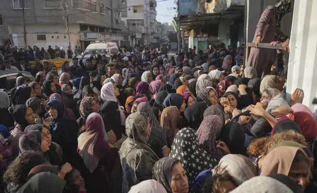 Residents gather in front of a bakery to get their share of bread in Deir al-Balah, Gaza Strip, Thursday, Nov. 21, 2024. (AP Photo/Abdel Kareem Hana)