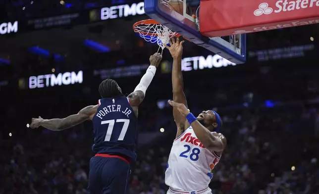 Philadelphia 76ers' Guerschon Yabusele, right, goes up for a shot against Los Angeles Clippers' Kevin Porter Jr. during the first half of an NBA basketball game, Sunday, Nov. 24, 2024, in Philadelphia. (AP Photo/Matt Slocum)