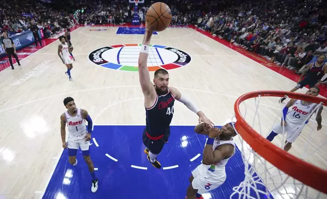 Los Angeles Clippers' Ivica Zubac (40) goes up for a dunk against Philadelphia 76ers' Guerschon Yabusele (28) during the first half of an NBA basketball game, Sunday, Nov. 24, 2024, in Philadelphia. (AP Photo/Matt Slocum)