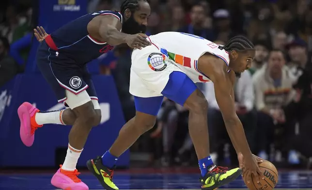 Philadelphia 76ers' Tyrese Maxey, right, and Los Angeles Clippers' James Harden chase a loose ball during the first half of an NBA basketball game, Sunday, Nov. 24, 2024, in Philadelphia. (AP Photo/Matt Slocum)