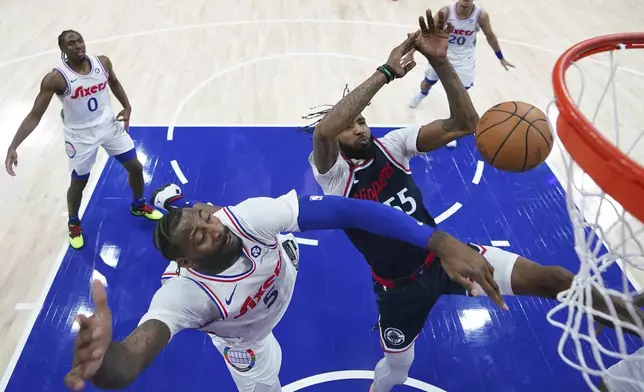 Los Angeles Clippers' Derrick Jones Jr. (55) cannot get a shot past Philadelphia 76ers' Andre Drummond (5) during the first half of an NBA basketball game, Sunday, Nov. 24, 2024, in Philadelphia. (AP Photo/Matt Slocum)