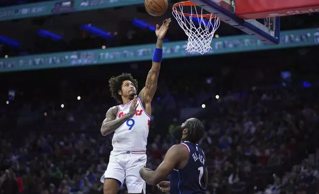 Philadelphia 76ers' Kelly Oubre Jr., left, goes up for a shot against Los Angeles Clippers' James Harden during the first half of an NBA basketball game, Sunday, Nov. 24, 2024, in Philadelphia. (AP Photo/Matt Slocum)