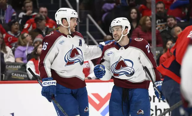 Colorado Avalanche right wing Mikko Rantanen (96) celebrates his goal with left wing Jonathan Drouin (27) during the second period of an NHL hockey game against the Washington Capitals, Thursday, Nov. 21, 2024, in Washington. (AP Photo/Nick Wass)