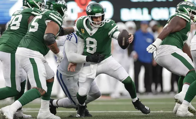 New York Jets quarterback Aaron Rodgers (8) tries to avoid a sack from Indianapolis Colts defensive end Kwity Paye (51) during the fourth quarter of an NFL football game, Sunday, Nov. 17, 2024, in East Rutherford, N.J. (AP Photo/Adam Hunger)