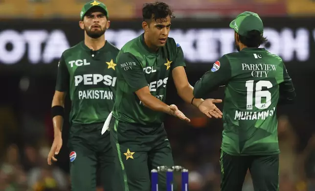 Pakistan's Abbas Afridi celebrates with teammate Mohammad Rizwan, right, after dismissing Australia's Glenn Maxwell during the T20 cricket international between Pakistan and Australia at the Gabba in Brisbane, Australia, Thursday, Nov. 14, 2024. (AP Photo/Tertius Pickard)