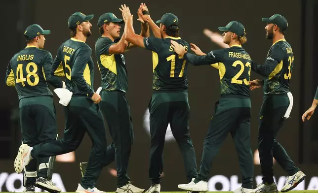 Australian players celebrate after dismissing Pakistan's Sahibzada Farhan during the T20 cricket international between Pakistan and Australia at the Gabba in Brisbane, Australia, Thursday, Nov. 14, 2024. (AP Photo/Tertius Pickard)