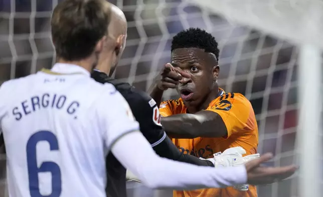 Real Madrid's Vinicius Junior gestures at Leganes' Sergio Gonzalez, foreground, during a Spanish La Liga soccer match between CD Leganes and Real Madrid in Leganes, outside Madrid, Sunday, Nov. 24, 2024. (AP Photo/Bernat Armangue)