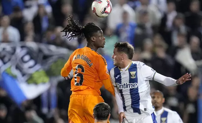 Real Madrid's Eduardo Camavinga, left, jumps for the ball with Leganes' Julian Chicco during a Spanish La Liga soccer match between CD Leganes and Real Madrid in Leganes, outside Madrid, Sunday, Nov. 24, 2024. (AP Photo/Bernat Armangue)