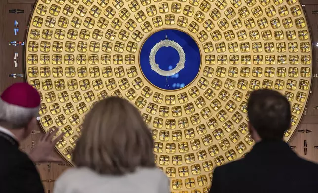 French President Emmanuel Macron, right, looks at the reliquary of the Crown of Thorns designed by French Artist Sylvain Dubuisson as he visits the restored interiors of the Notre-Dame de Paris cathedral, Friday, Nov. 29, 2024 in Paris. (Christophe Petit Tesson/Pool via AP)