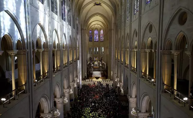 French President Emmanuel Macron delivers a speech to construction workers inside the Notre-Dame de Paris cathedral after visiting the restored interiors of the monument, Friday, Nov. 29, 2024 in Paris. (Sarah Meyssonnier/Pool via AP)