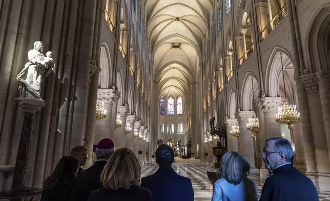 French President Emmanuel Macron, center, and his wife Brigitte Macron, second right, visit the restored interiors of the Notre-Dame de Paris cathedral, Friday, Nov. 29, 2024 in Paris. (Christophe Petit Tesson/Pool via AP)