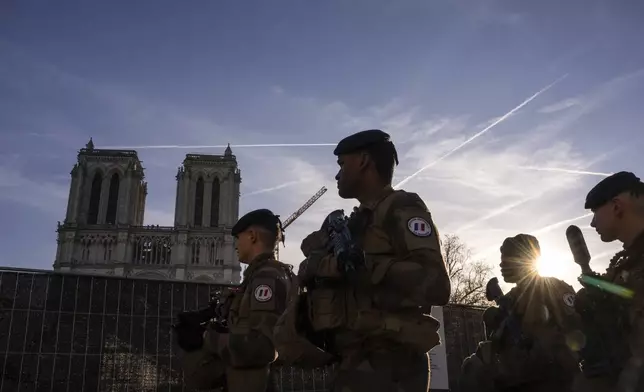 France's anti-terror Sentinelle operation soldiers patrol as French President Emmanuel Macron visits the renovated Notre Dame Cathedral in Paris, Friday, Nov. 29, 2024. (AP Photo/Louise Delmotte)