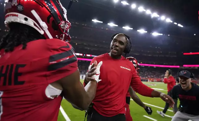 Houston Texans wide receiver John Metchie III, left, celebrates with head coach DeMeco Ryans after catching a 15-yard touchdown pass during the first half of an NFL football game against the Detroit Lions, Sunday, Nov. 10, 2024, in Houston. (AP Photo/Eric Christian Smith)