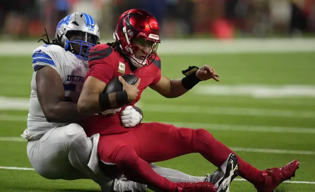 Houston Texans quarterback C.J. Stroud is sacked by Detroit Lions defensive tackle Alim McNeill, left, during the second half of an NFL football game, Sunday, Nov. 10, 2024, in Houston. (AP Photo/Eric Christian Smith)