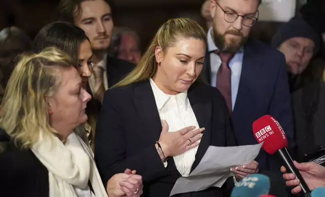Nikita Hand, who is also known as Nikita Ni Laimhin, center, speaks with the media outside the High Court in Dublin, Ireland, Friday, Nov. 22, 2024, after a civil jury found that mixed martial arts fighter Conor McGregor sexually assaulted her in a hotel penthouse after a night of heavy partying. (Brian Lawless/PA via AP)