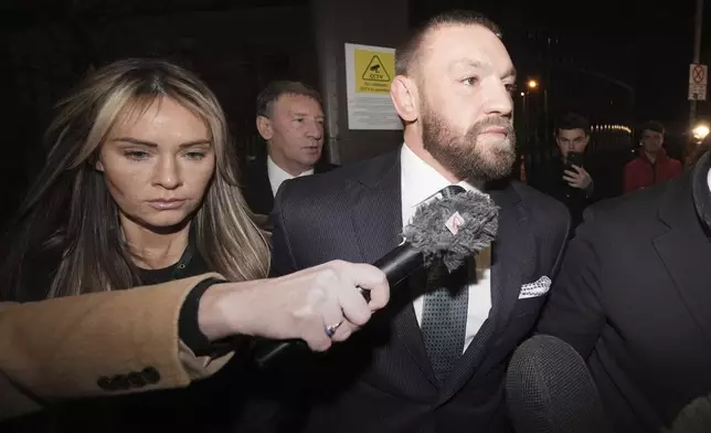 Conor McGregor and partner Dee Devlin leave the High Court in Dublin, Ireland, Friday, Nov. 22, 2024, after a civil jury found that mixed martial arts fighter sexually assaulted a woman in a hotel penthouse after a night of heavy partying. (Brian Lawless/PA via AP)