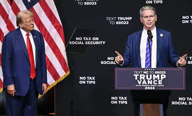 FILE - Republican presidential nominee former President Donald Trump, left, listens as investor Scott Bessent speaks on the economy in Asheville, N.C., Aug. 14, 2024. (AP Photo/Matt Kelley, File)