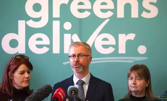 Green leader Roderic O'Gorman, center, speaks to the media during a press conference at the Irish Architectural Archive, on the last day of campaigning on the eve of the General Election, in Dublin, Thursday, Nov. 28, 2024. (Brian Lawless/PA via AP)