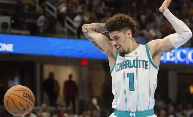 Charlotte Hornets' LaMelo Ball (1) watches the ball during the second half of an NBA basketball game against the Cleveland Cavaliers in Cleveland, Sunday, Nov 17, 2024. (AP Photo/Phil Long)