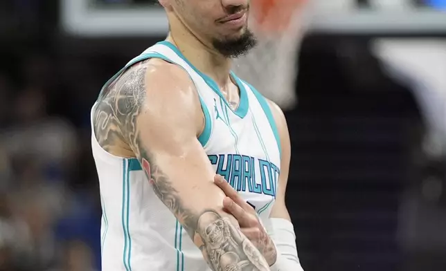 Charlotte Hornets guard LaMelo Ball gestures after making a 3-point shot against the Orlando Magic during the first half of an Emirates NBA Cup basketball game, Tuesday, Nov. 12, 2024, in Orlando, Fla. (AP Photo/John Raoux)