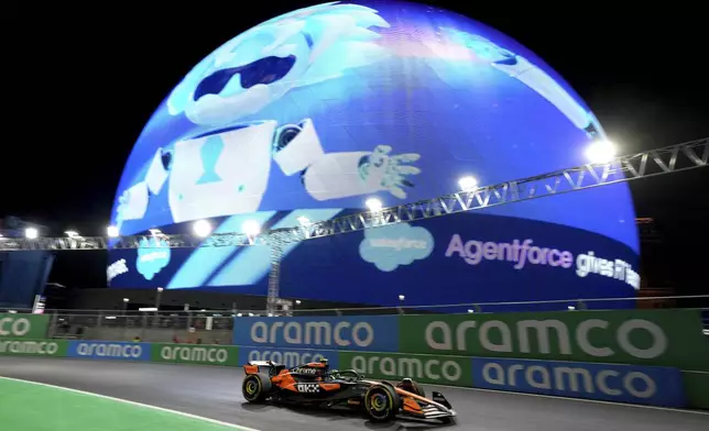 McLaren driver Lando Norris, of Britain, drives past the Sphere during a practice session for the Formula One U.S. Grand Prix auto race, Thursday, Nov. 21, 2024, in Las Vegas. (AP Photo/Rick Scuteri)