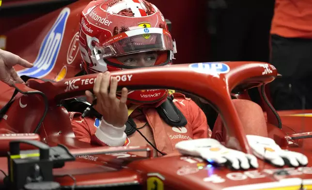 Ferrari driver Charles Leclerc, of Monaco, gets in his car during a practice session for the Formula One U.S. Grand Prix auto race, Thursday, Nov. 21, 2024, in Las Vegas. (AP Photo/Matt York)