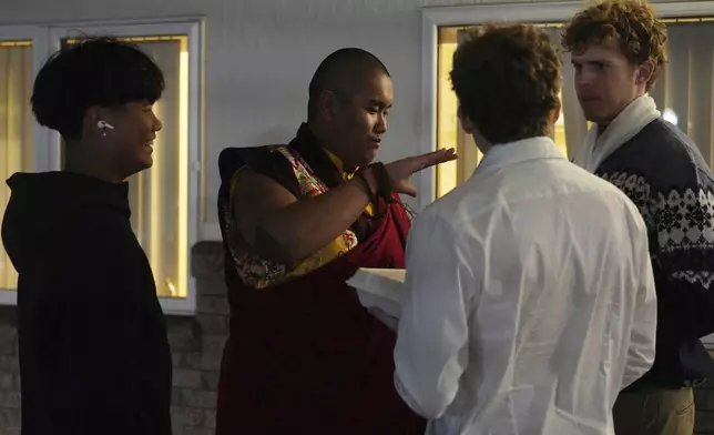 U.S.-born Buddhist lama, Jalue Dorje, talks with his high school friends near the end of his 18th birthday and enthronement ceremony, in Isanti, Minn., on Saturday, Nov. 9, 2024. (AP Photo/Jessie Wardarski)