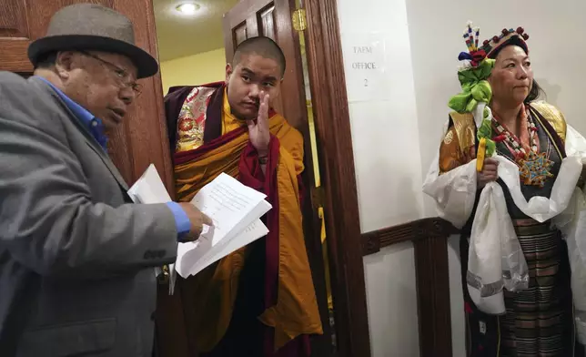 U.S.-born Buddhist lama, Jalue Dorje, center, calls for his dad before making an entrance at his 18th birthday and enthronement ceremony in Isanti, Minn., on Saturday, Nov. 9, 2024. (AP Photo/Jessie Wardarski)