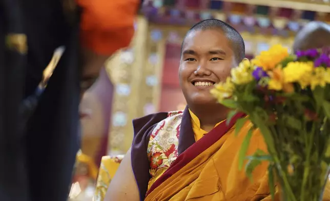 U.S.-born Buddhist lama, Jalue Dorje, is presented with “khata,” the Tibetan ceremonial scarves that symbolize auspiciousness, at his 18th birthday and enthronement ceremony, in Isanti, Minn., on Saturday, Nov. 9, 2024. (AP Photo/Jessie Wardarski)