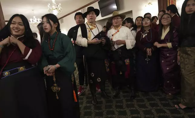 Guests prepare to welcome U.S.-born Buddhist lama, Jalue Dorje, during his 18th birthday and enthronement ceremony at the Tibetan American Foundation of Minnesota in Isanti, Minn., on Saturday, Nov. 9, 2024. (AP Photo/Luis Andres Henao)