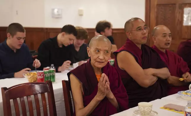 Monks and high school students attend the 18th birthday and enthronement ceremony for U.S.-born Buddhist lama, Jalue Dorje, in Isanti, Minn., on Saturday, Nov. 9, 2024. (AP Photo/Jessie Wardarski)