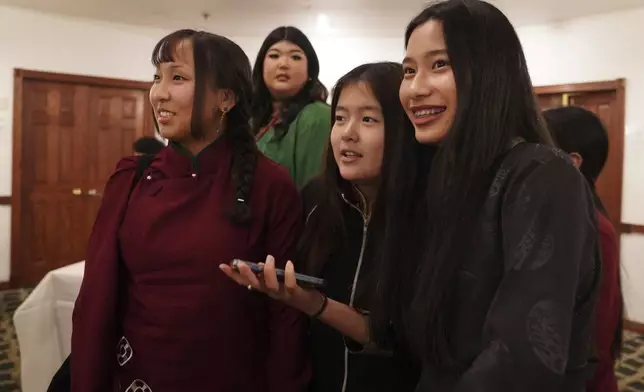 Friends, family, and community members attend the 18th birthday and enthronement ceremony of U.S.-born Buddhist lama, Jalue Dorje, at the Tibetan American Foundation of Minnesota in Isanti, Minn., on Saturday, Nov. 9, 2024. (AP Photo/Jessie Wardarski)