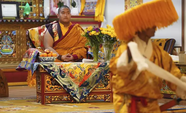 U.S.-born Buddhist lama, Jalue Dorje, watches a traditional Tibetan performance at his 18th birthday and enthronement ceremony in Isanti, Minn., on Saturday, Nov. 9, 2024. (AP Photo/Jessie Wardarski)