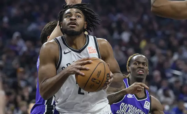 Brooklyn Nets guard Cam Thomas, front left, drives to the basket during the first half of an NBA basketball game against the Sacramento Kings in Sacramento, Calif., Sunday, Nov. 24, 2024. (AP Photo/Randall Benton)