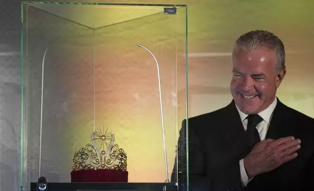 Mexican businessman Raúl Rocha Cantú, co-owner of the Miss Universe Beauty Pageant, poses for a photo next to an official Miss Universe crown during a media presentation at the Mexico City Arena, in Mexico City, Wednesday, Nov. 13, 2024. (AP Photo/Fernando Llano)