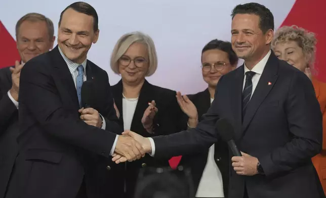 Poland's Foreign Minister Radek Sikorsk, left, stands on stage with Warsaw Mayor Rafal Trzaskowski, right, for a presidential election announcement in Warsaw, Poland, on Saturday Nov. 23, 2024. (AP Photo/Czarek Sokolowski)