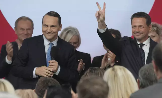 Poland's Foreign Minister Radek Sikorsk, left, stands on stage with Warsaw Mayor Rafal Trzaskowski, right, for a presidential election announcement in Warsaw, Poland, on Saturday Nov. 23, 2024. (AP Photo/Czarek Sokolowski)