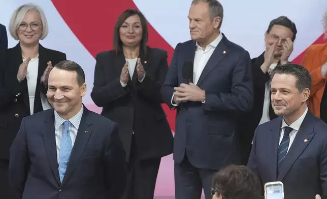 Poland's Foreign Minister Radek Sikorsk, front left, stands on stage with Warsaw Mayor Rafal Trzaskowski, front right, for a presidential election announcement in Warsaw, Poland, on Saturday Nov. 23, 2024. (AP Photo/Czarek Sokolowski)