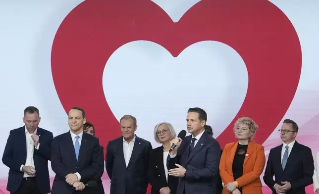 Warsaw Mayor Rafal Trzaskowski, front, speak during a presidential election announcement in Warsaw, Poland, on Saturday Nov. 23, 2024. (AP Photo/Czarek Sokolowski)