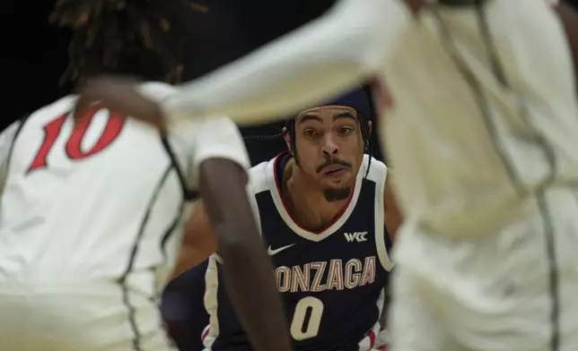 Gonzaga guard Ryan Nembhard (0) tries to get past San Diego State guard BJ Davis during the first half of an NCAA college basketball game Monday, Nov. 18, 2024, in San Diego. (AP Photo/Gregory Bull)