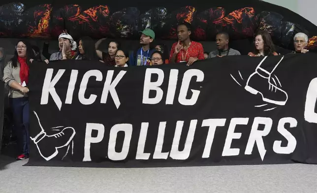 Activists participate in a demonstration against fossil fuels at the COP29 U.N. Climate Summit, Friday, Nov. 15, 2024, in Baku, Azerbaijan. (AP Photo/Joshua A. Bickel)