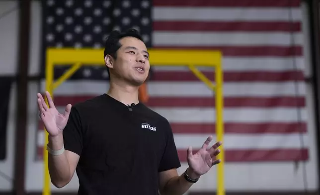 Hector Xu, CEO of Rotor Technologies, gestures during an interview at the company's hanger where unmanned semi-autonomous helicopters are being assembled, Monday, Nov. 11, 2024, in Nashua, N.H. (AP Photo/Charles Krupa)